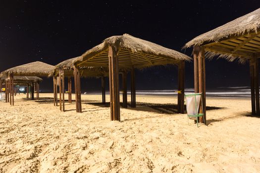 canopies from sun on the beach at night
