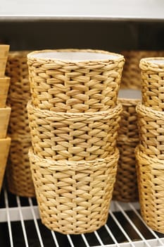 woven straw baskets on a shelf in a store.