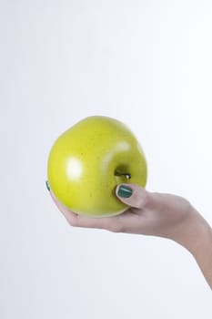 Green apple in hand on white background