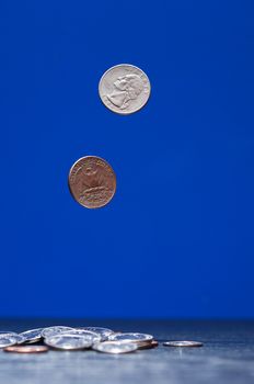 Pair of flying coins on dark blue background