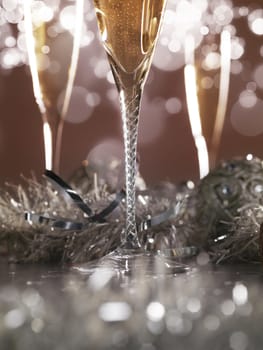Elegant champagne glasses on dark golden background