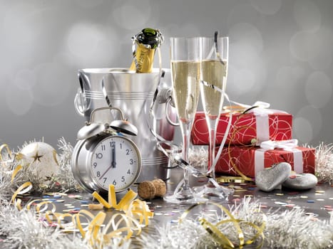 New Year composition with champagne and gifts on a silver background