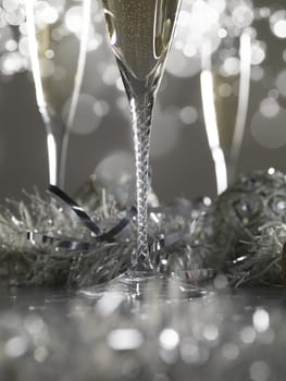 Three luxury champagne glasses on a grey bokeh background