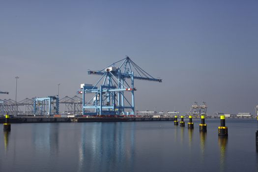 Row of large harbor cranes in the rotterdam harbor. The Netherlands