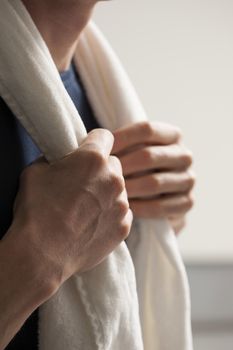 White towel over shoulders of single man over white background