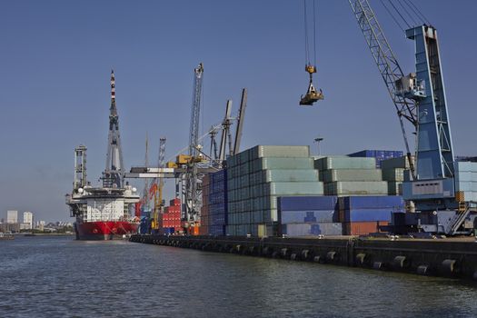 big container ships with cranes in the harbor of rotterdam netherlands
