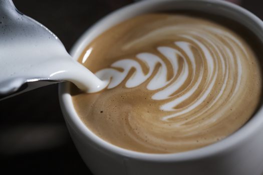 Making latte Art on a Cappucinno. Freshly made