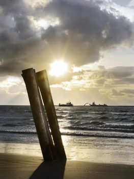 dredgers in the late afternoon sun before a beach