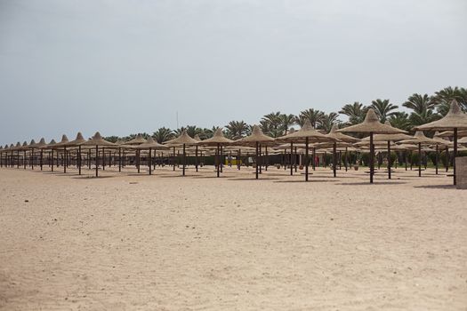 Tropical beach with umbrellas Red sea, hotel and resorton Egypt