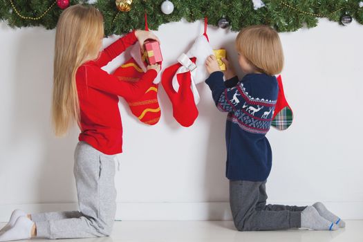 Children take christmas gifts from Stockings