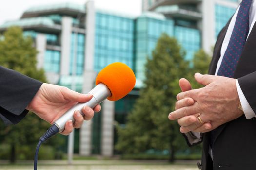 Female journalist conducting an interview with business person or politician