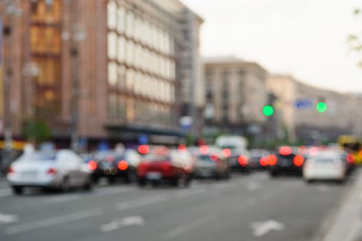 cars in big city on road with blurred focus.