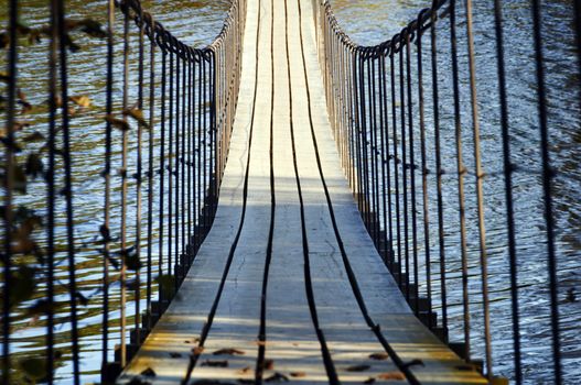 Wooden suspension bridge hanging over the river