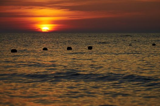 Fishing net in the sea at the sunset