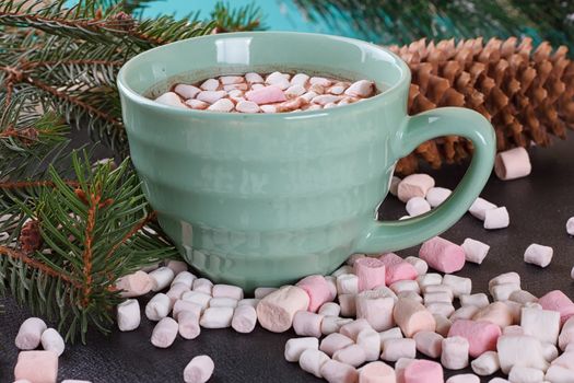 mug with hot chocolate and burning lantern on wooden table