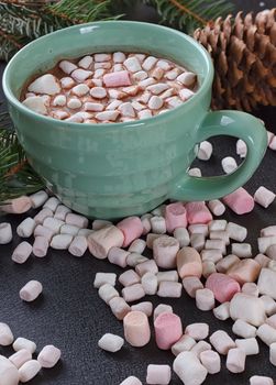 mug with hot chocolate and burning lantern on wooden table