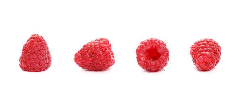 Four fresh red ripe mellow raspberry berries isolated on white background, detail close up in different perspectives, low angle view