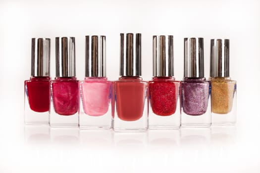 Little bottles with enamel on an isolated studio background