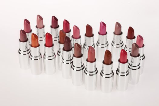 Tubes with different kinds of lipstick on studio background