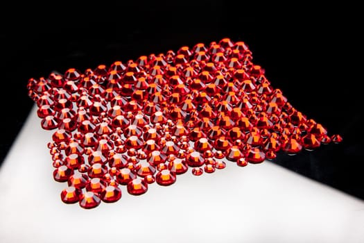 Red crystals on a glass studio background