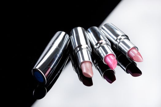 Metal tubes with lipstick on an isolted studio background