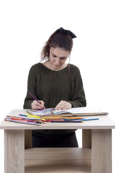 Young girl artist drawing pencils on white background