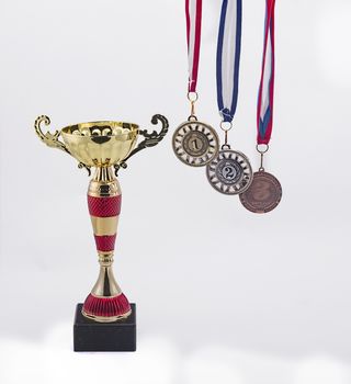 sports medals of gold silver and bronze for the first second and third place and Cup