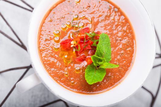 Bowl of Fresh tomato soup Gazpacho in white plate.