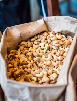 cashew nuts in a paper bag for sale