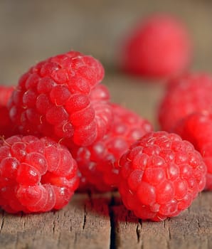 Ripe and fresh raspberry on wooden table