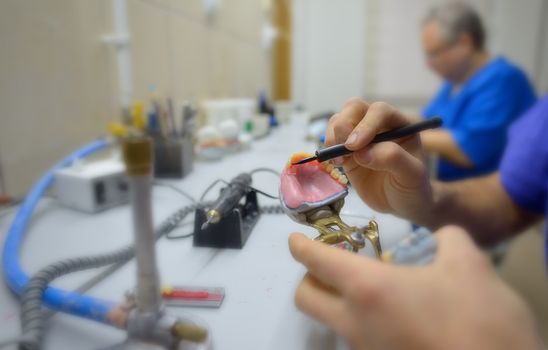 Closeup of dental technician in laboratory