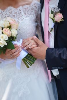 groom holding brides hand at the wedding walk.