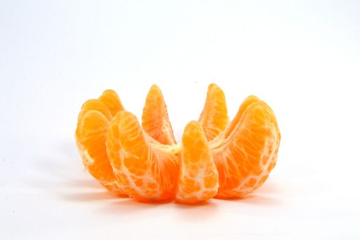 Bowl of tangerine parts on a white background