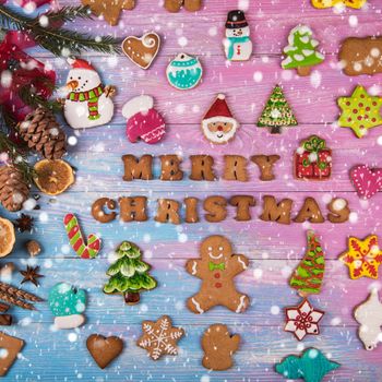 Different ginger cookies for new years and christmas on wooden background, top view