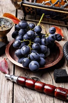 Smoking hookah accessories and tobacco with taste of grapes