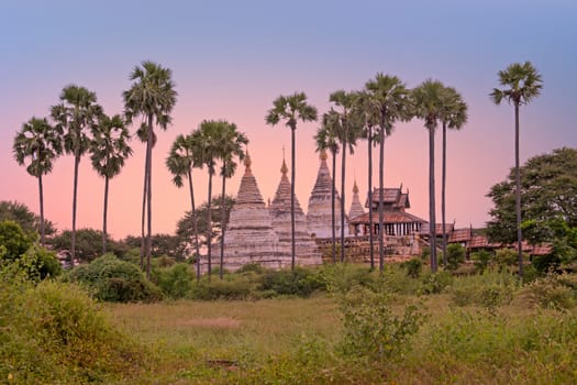 Ancient pagodas in the countryside from Bagan in Myanmar at sunset