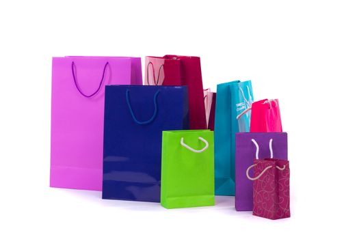 Composition of colourful and bright shopping packages for gifts and presents isolated on white