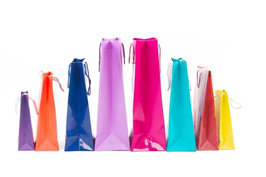 Composition of colourful and bright shopping packages for gifts and presents isolated on white