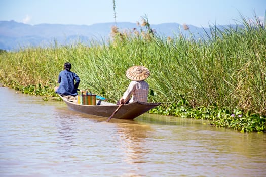 Inthas travel on boat in Inle, Myanmar. Travel by boat is the major transportation mean both local and tourists in Inle lake.