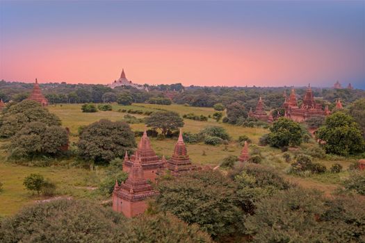 Ancient pagodas in the landscape from Bagan in Myanmar at sunset