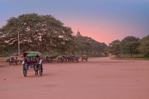 Horse carts on a dusty road in the temple area in Bagan Myanmar