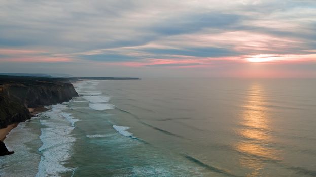 Aerial from a beautiful sunset at Vale Figueiras beach in Portugal