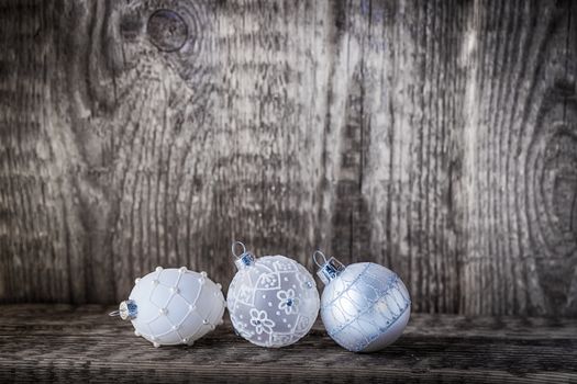 White christmas balls on a wooden background.