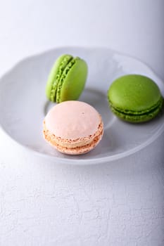 Plate of colorful macaroons on a white plate