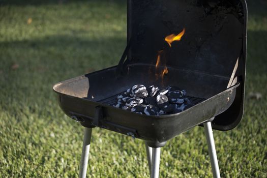 Flaming charcoal in barbecue pit
