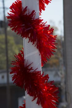 Red Christmas garland wrapped around pole
