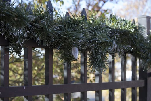 Christmas lights and garland on a fence