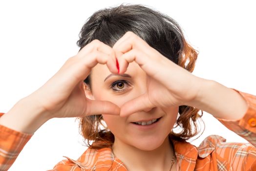 young girl shows hands a heart on a white background