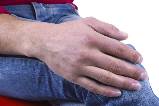 Young male hand on his knee on a white background