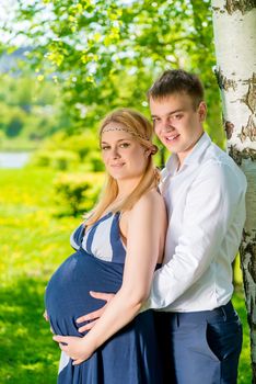 husband and wife are waiting for their first child, photographing in the park